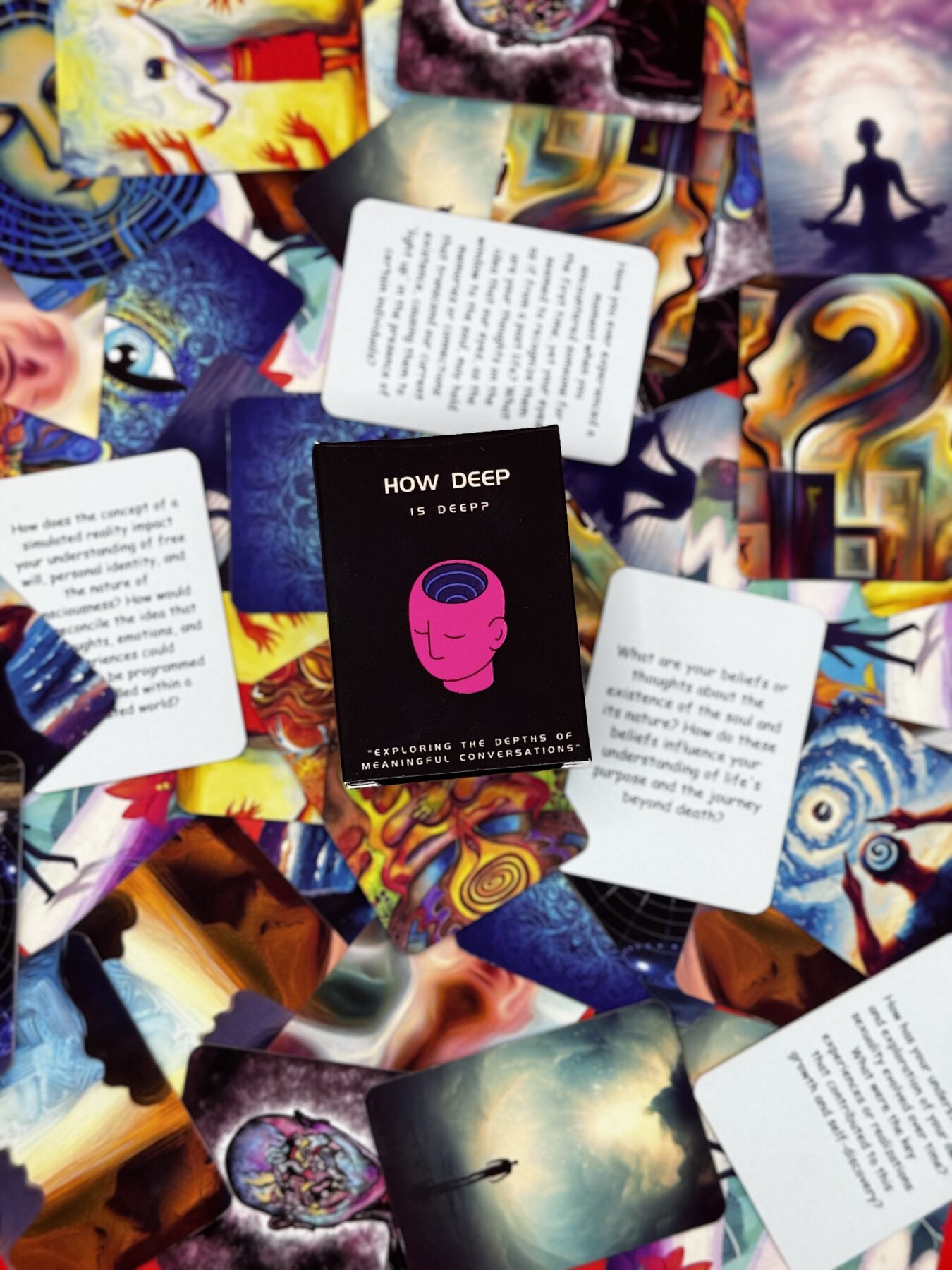 The box centered among scattered cards with surreal artwork