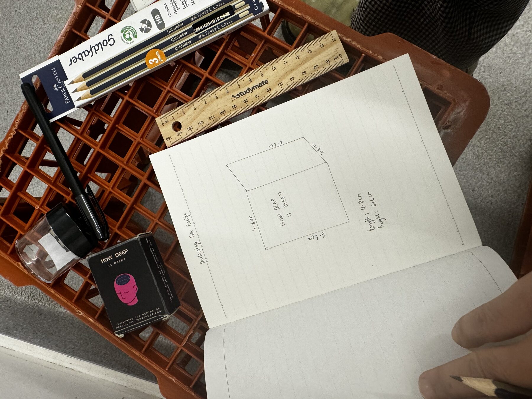Hand-drawn sketches of the box design with measurements